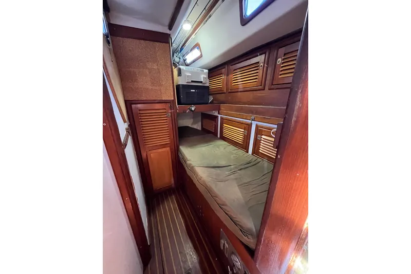 Slide: The Image of Cozy cabin interior of 1993 Med Marine Montevideo 43 with wooden storage and bedding. - 23