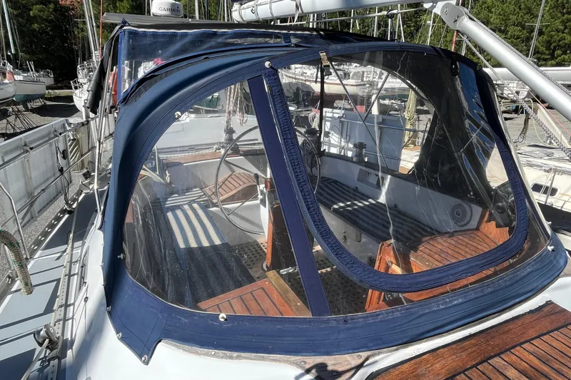 Slide: The Image of Cockpit of 1993 Med Marine Montevideo 43 sailboat with blue canopy and wooden seating. - 6