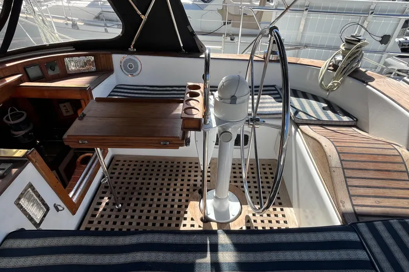 Slide: The Image of Cockpit of 1993 Med Marine Montevideo 43 yacht with wooden accents and steering wheel. - 7