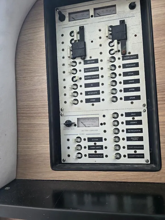 Slide: The Image of Electrical panel on a 2008 Donzi 38 ZSF boat, featuring labeled switches and meters. - 15