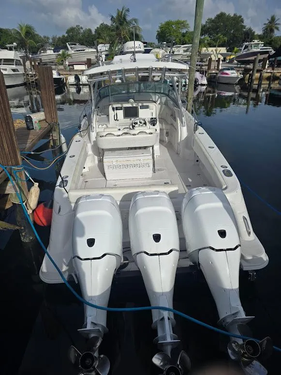 Slide: The Image of 2008 Donzi 38 ZSF boat with triple outboard engines docked at marina. - 18