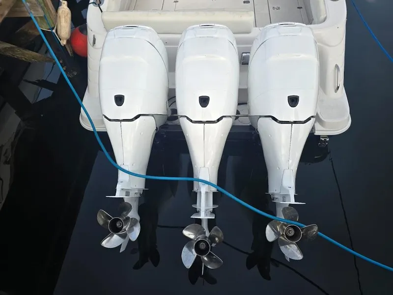 Slide: The Image of Triple outboard motors on a 2008 Donzi 38 ZSF boat, docked. - 19