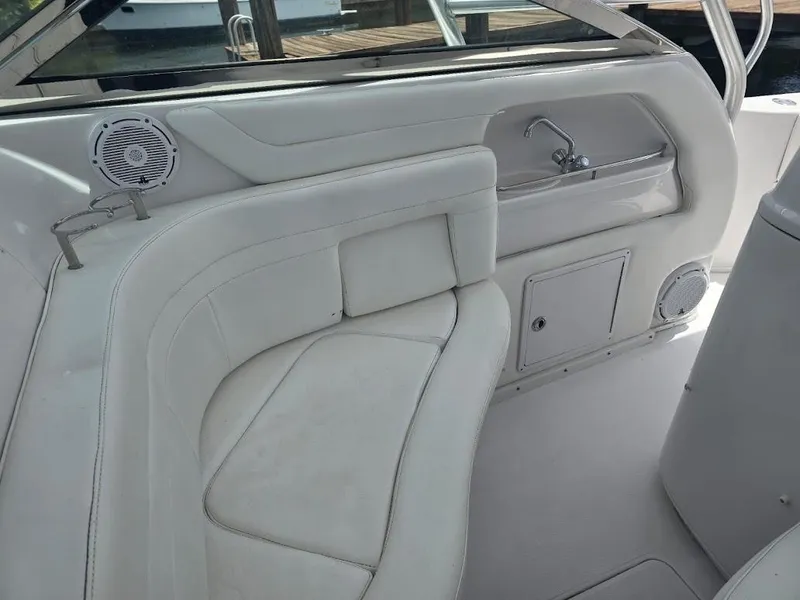 Slide: The Image of 2008 Donzi 38 ZSF boat interior with white seating and built-in sink. - 8