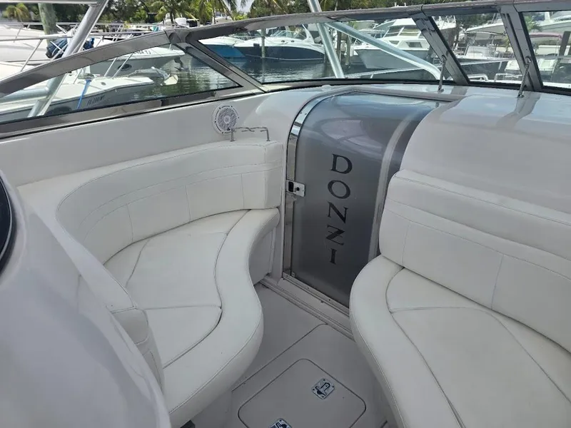Slide: The Image of 2008 Donzi 38 ZSF boat interior with white seating and branded door. - 9