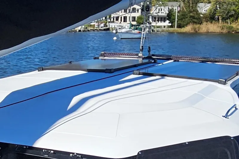 Slide: The Image of 2022 Seawind 1160 Lite catamaran on calm water, featuring sleek deck design. - 3