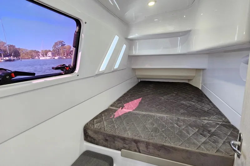 Slide: The Image of Cozy cabin interior of 2022 Seawind 1160 Lite catamaran with window view. - 8