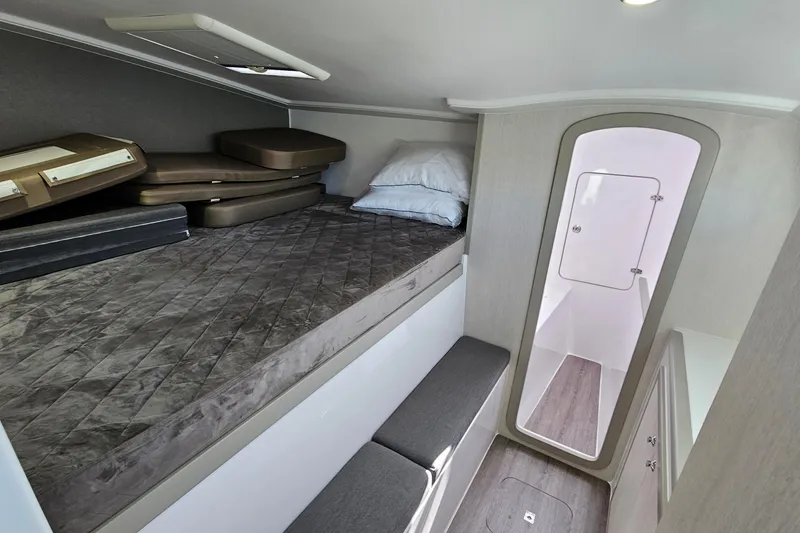 Slide: The Image of 2022 Seawind 1160 Lite cabin interior with bed, cushions, and modern design. - 9