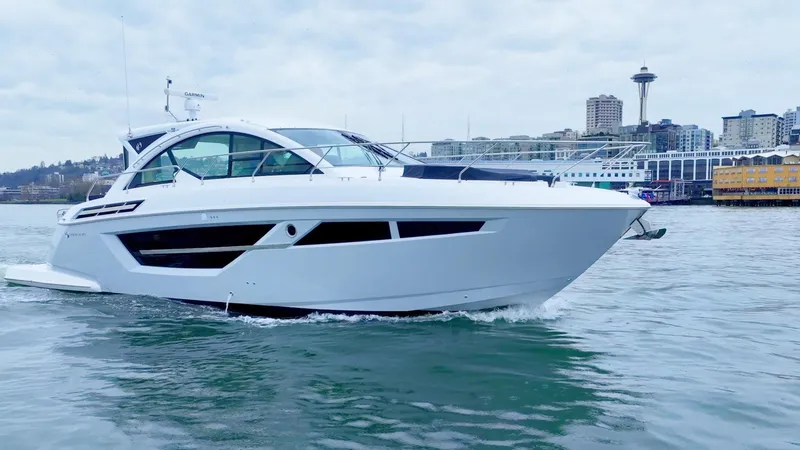Slide: The Image of 2024 Cruisers Yachts 50 Cantius on water with city skyline background. - 1
