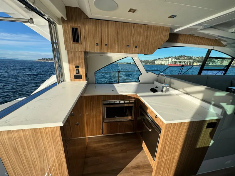 Slide: The Image of Modern kitchen on 2024 Cruisers Yachts 50 Cantius with ocean view. - 15
