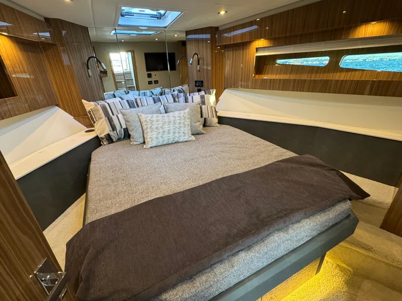 Slide: The Image of Luxurious bedroom interior of 2024 Cruisers Yachts 50 Cantius with modern design and ample lighting. - 19