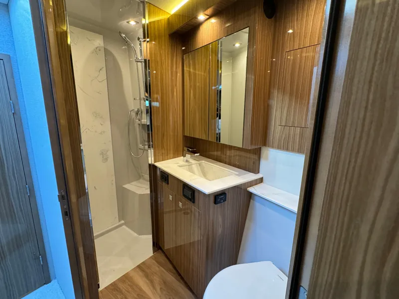 Slide: The Image of Luxurious bathroom in 2024 Cruisers Yachts 50 Cantius with modern fixtures and wood accents. - 20