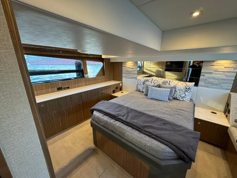 Slide: The Image of Luxurious bedroom interior of 2024 Cruisers Yachts 50 Cantius with modern design and waterfront view. - 23