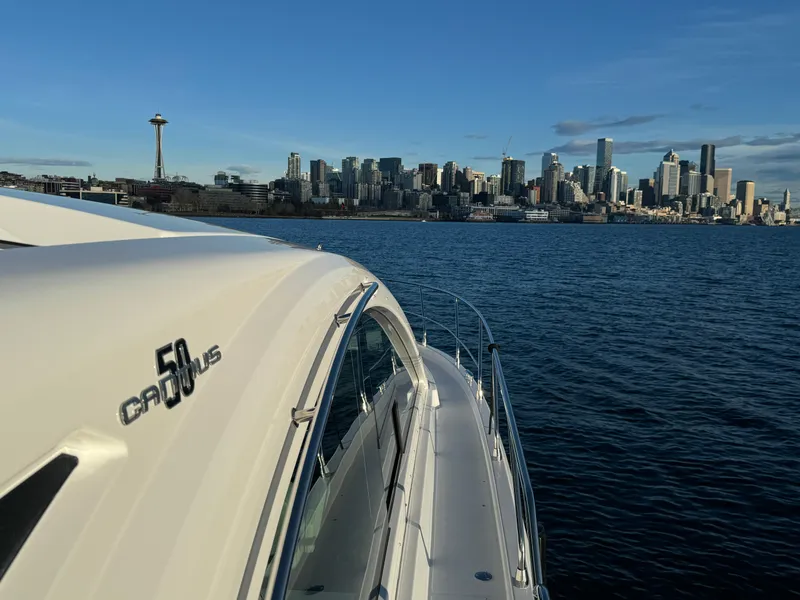 Slide: The Image of 2024 Cruisers Yachts 50 Cantius on water with city skyline in background. - 25
