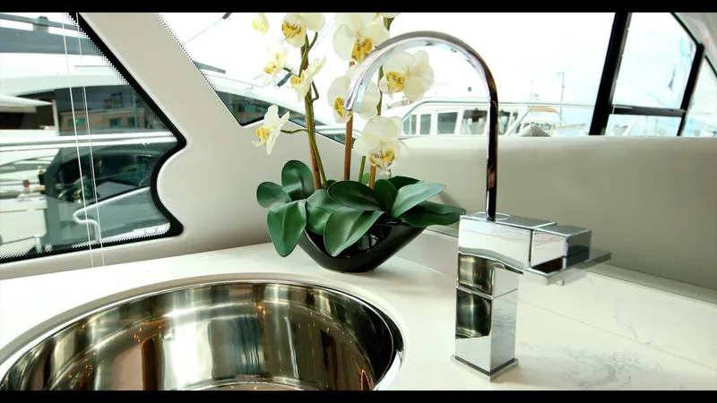 Slide: The Image of Modern kitchen sink and faucet on the 2024 Cruisers Yachts 50 Cantius. - 33