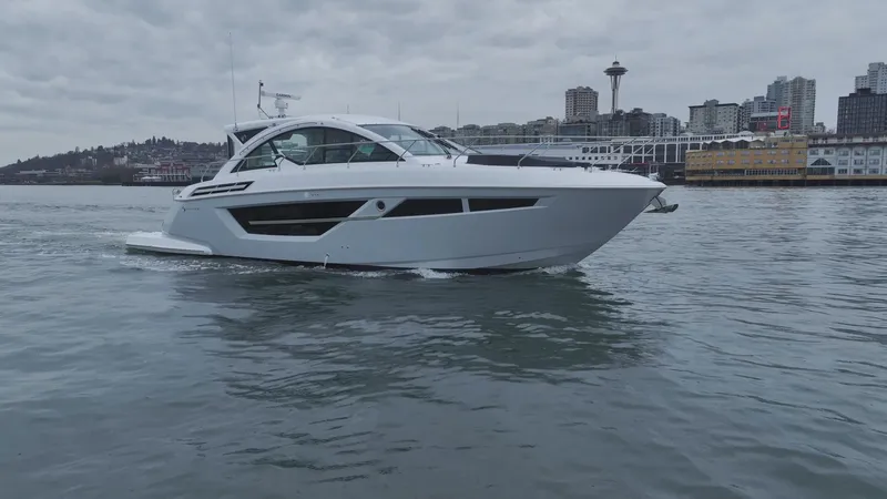 Slide: The Image of 2024 Cruisers Yachts 50 Cantius on water with city skyline background. - 7