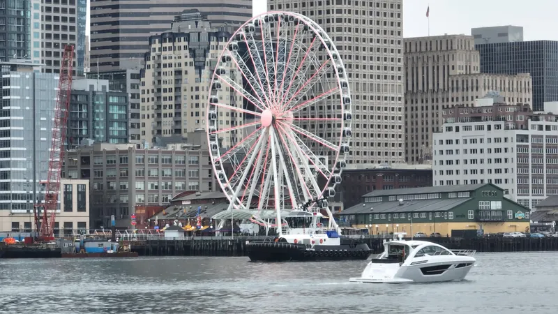 Slide: The Image of 2024 Cruisers Yachts 50 Cantius cruising near city waterfront with Ferris wheel. - 8