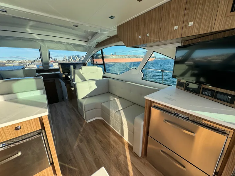 Slide: The Image of Interior of 2024 Cruisers Yachts 50 Cantius with modern furnishings and waterfront view. - 13