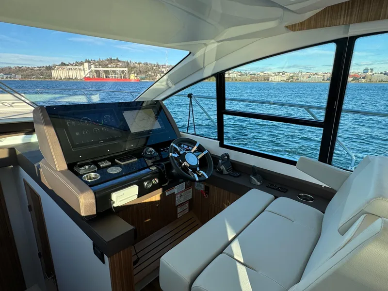 Slide: The Image of 2024 Cruisers Yachts 50 Cantius helm station with waterfront view. - 18