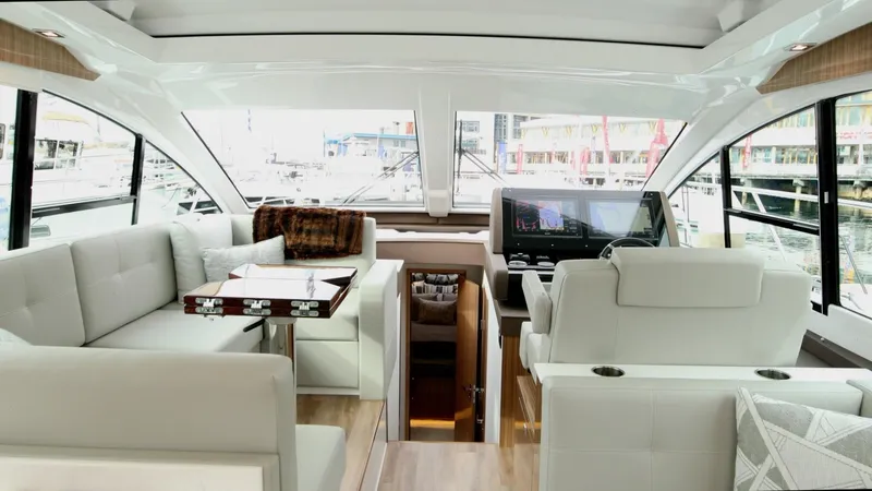 Slide: The Image of Interior of 2024 Cruisers Yachts 50 Cantius, featuring luxurious seating and modern helm. - 35