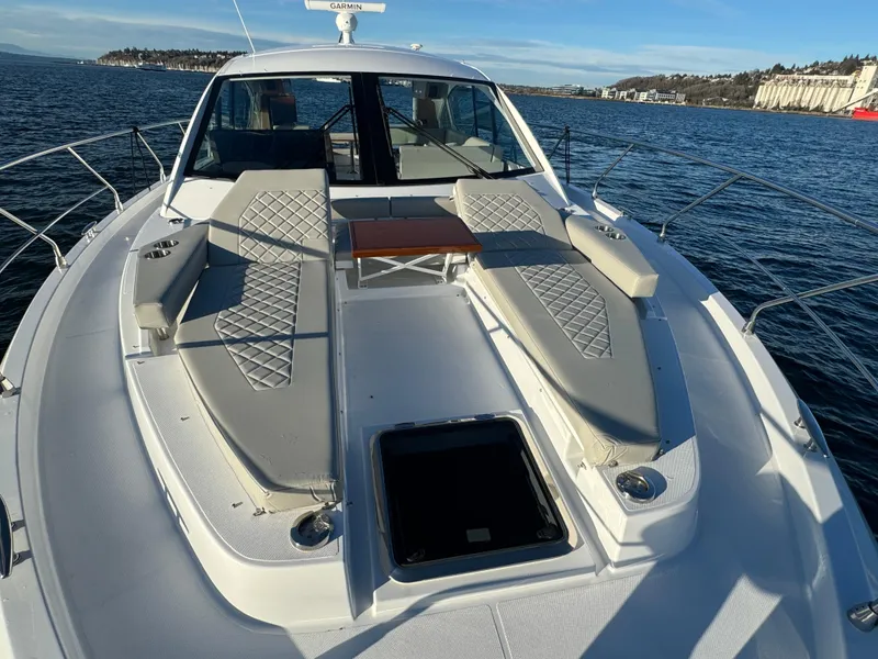 Slide: The Image of 2024 Cruisers Yachts 50 Cantius bow deck with sun loungers and table. - 9