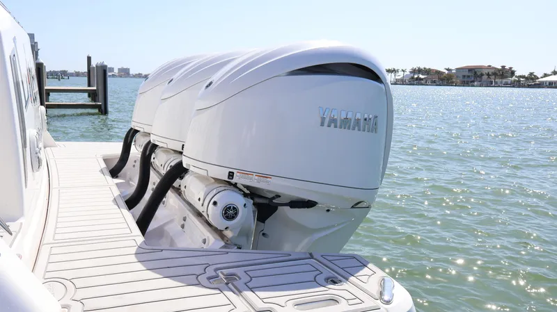 Slide: The Image of 2022 Regal 38 SAV boat with Yamaha outboard engines on a sunny waterfront. - 10