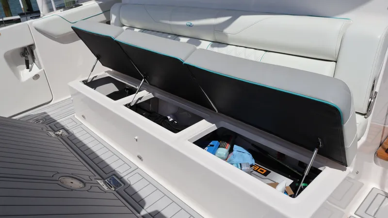 Slide: The Image of 2022 Regal 38 SAV boat storage compartments open on deck. - 17