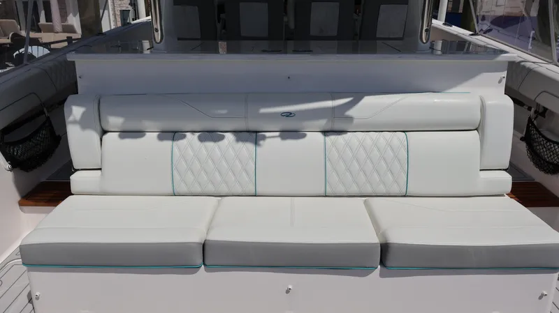 Slide: The Image of 2022 Regal 38 SAV boat with white cushioned seating and diamond stitching. - 18