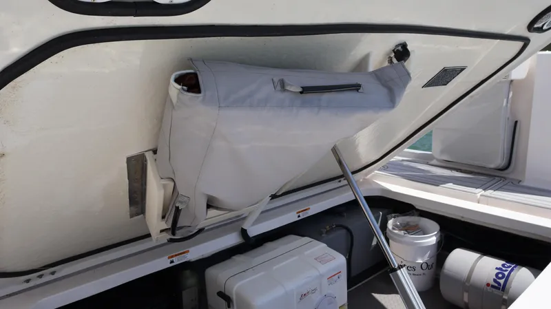 Slide: The Image of 2022 Regal 38 SAV boat storage compartment with gear and equipment. - 21