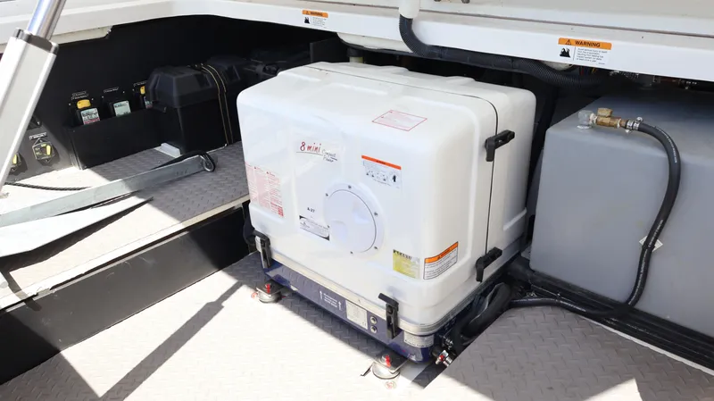 Slide: The Image of 2022 Regal 38 SAV boat engine compartment with generator and equipment. - 22