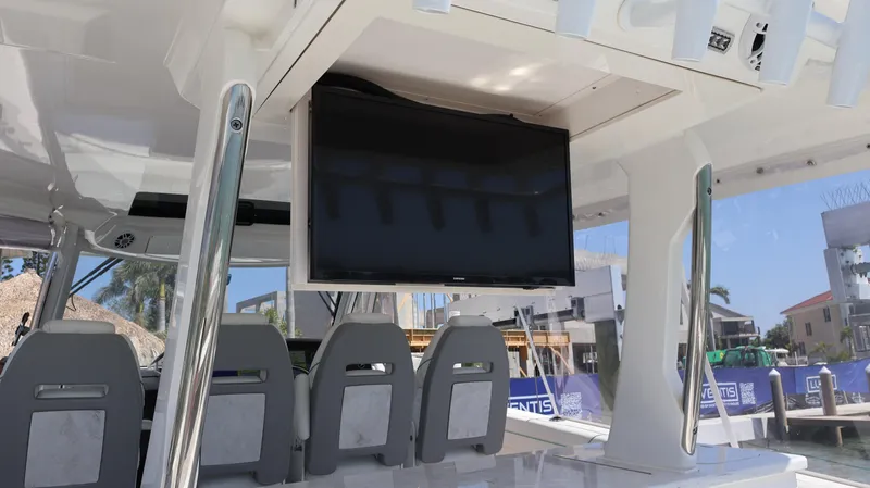 Slide: The Image of 2022 Regal 38 SAV boat interior with mounted TV and seating. - 25