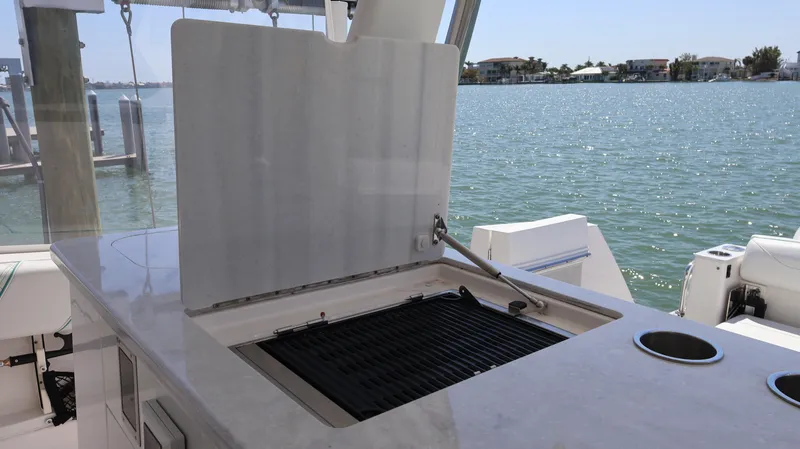 Slide: The Image of 2022 Regal 38 SAV boat with outdoor grill and ocean view. - 30