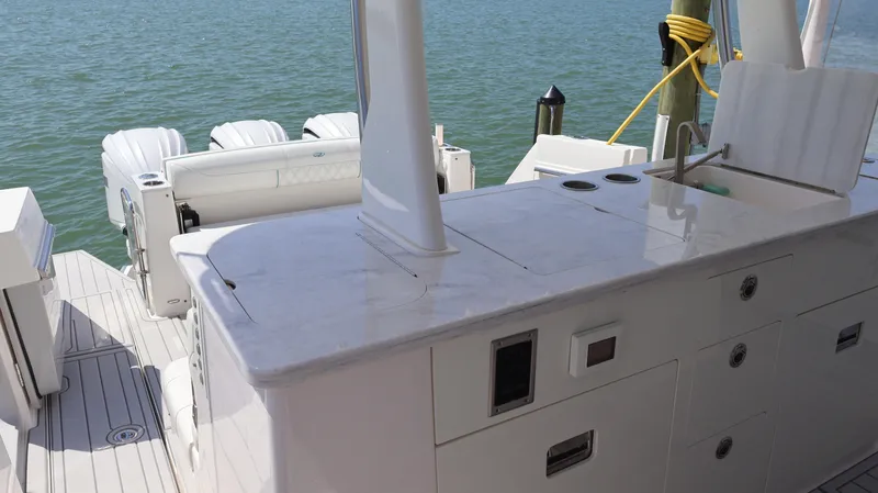 Slide: The Image of 2022 Regal 38 SAV boat with sleek deck and powerful engines on water. - 31