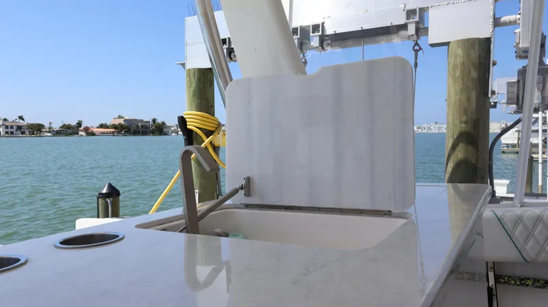 Slide: The Image of 2022 Regal 38 SAV boat interior with sink, docked by the water. - 32
