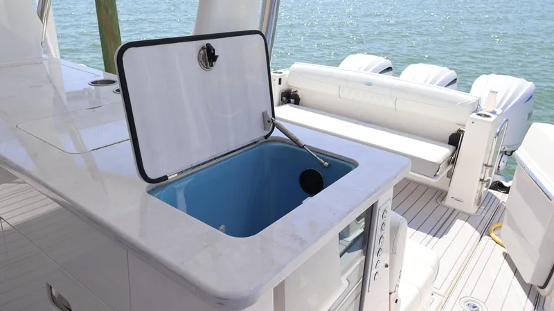 Slide: The Image of 2022 Regal 38 SAV boat interior with open storage compartment and seating area. - 33