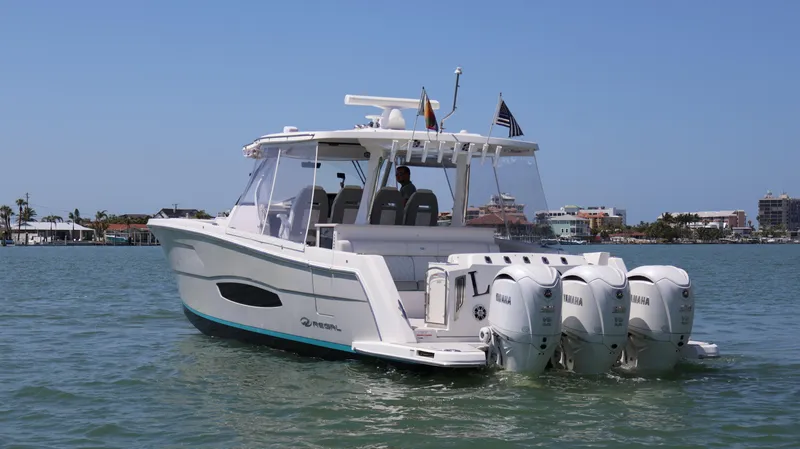 Slide: The Image of 2022 Regal 38 SAV boat with four Yamaha engines on a sunny day. - 4