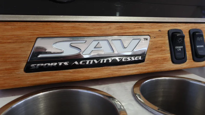 Slide: The Image of 2022 Regal 38 SAV Sports Activity Vessel logo on wooden panel with cup holders. - 47