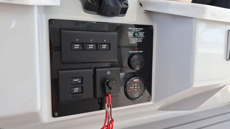 Slide: The Image of Control panel of 2022 Regal 38 SAV boat with ignition switches and safety features. - 48