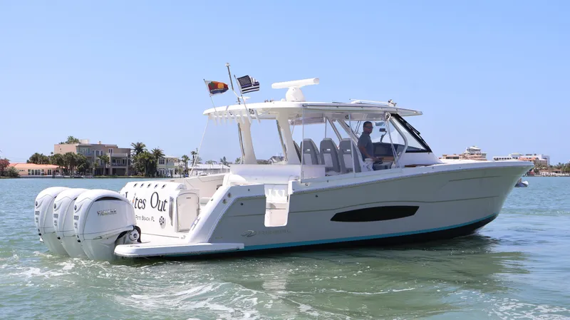 Slide: The Image of 2022 Regal 38 SAV boat cruising on a sunny day in coastal waters. - 6