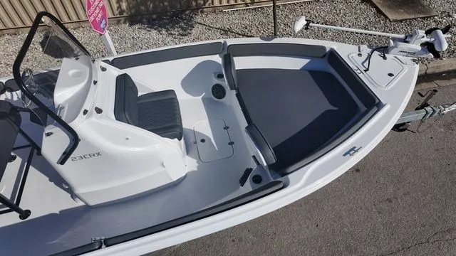 Slide: The Image of 2026 ALK2 Powerboats 23CRX, sleek white design, spacious deck, modern seating, and advanced controls. - 11