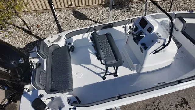 Slide: The Image of 2026 ALK2 Powerboats 23CRX interior with seating and control console, featuring modern design. - 12