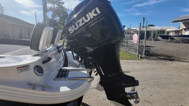 Slide: The Image of 2026 ALK2 Powerboats 23CRX with Suzuki outboard motor, parked outdoors. - 17