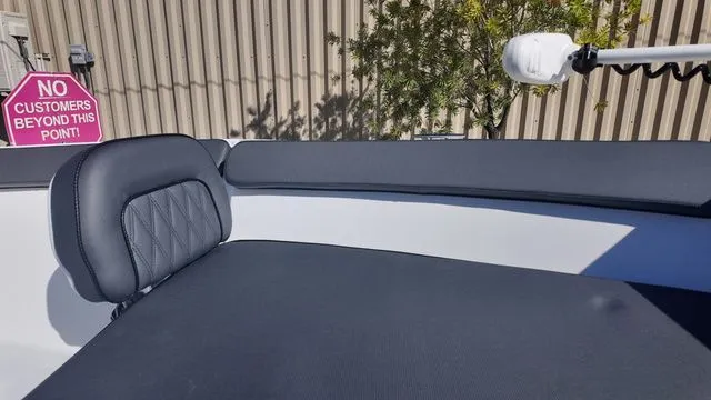 Slide: The Image of 2026 ALK2 Powerboats 23CRX interior with black seating, "No Customers" sign visible. - 23