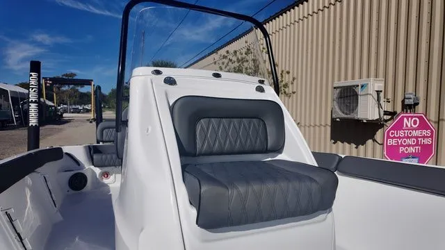 Slide: The Image of 2026 ALK2 Powerboats 23CRX with sleek seating, docked near a marine facility. - 25