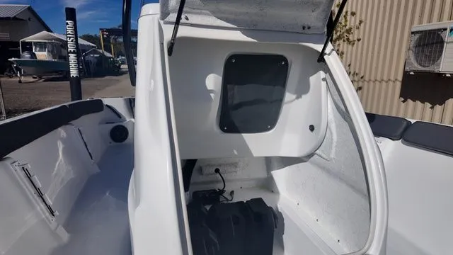 Slide: The Image of 2026 ALK2 Powerboats 23CRX interior storage compartment with open hatch. - 28