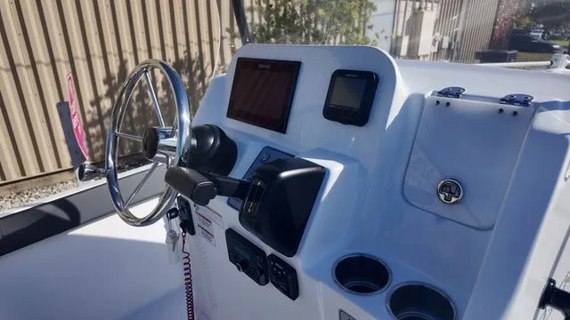 Slide: The Image of 2026 ALK2 Powerboats 23CRX dashboard with steering wheel and electronic controls. - 3