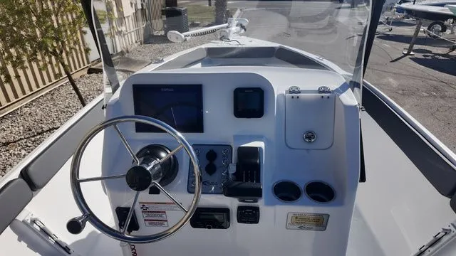 Slide: The Image of 2026 ALK2 Powerboats 23CRX dashboard with steering wheel and control panel. - 30
