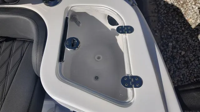Slide: The Image of 2026 ALK2 Powerboats 23CRX storage compartment with transparent lid and secure latches. - 38