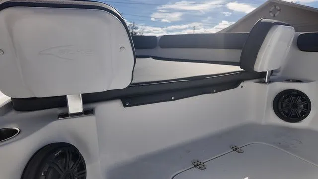 Slide: The Image of 2026 ALK2 Powerboats 23CRX interior with seating and speakers under a clear sky. - 40