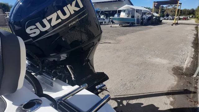 Slide: The Image of 2026 ALK2 Powerboats 23CRX with Suzuki engine in a boatyard setting. - 41