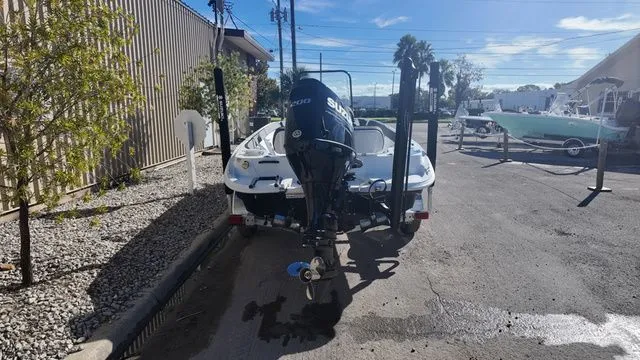 Slide: The Image of 2026 ALK2 Powerboats 23CRX with Suzuki outboard motor, parked outdoors on a sunny day. - 7